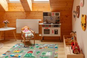 a kitchen with a doll in a chair in a room at Srub Chodov in Chodov