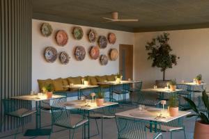 a dining room with tables and plates on the wall at Hotel Riviera Costa del Sol - Adults Recommended in Benalmádena +63 photos