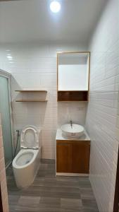 a bathroom with a toilet and a sink at Berchby Loft in Digos