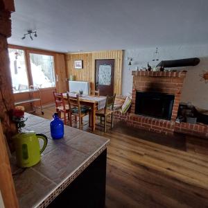 a living room with a table and a fireplace at Sonnentor in Bad Wurzach