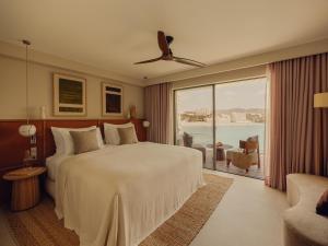 a bedroom with a large bed and a large window at Aethos Hotel Mallorca in Paguera +89 photos