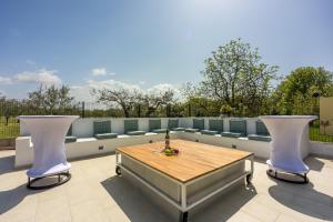 a patio with a wooden table and two chairs at Apartments Covic in Antonci