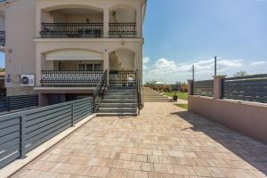 a building with stairs and a balcony on it at Apartments Covic in Antonci +20 photos