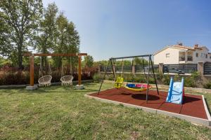 a playground in a yard with a swing at Apartments Covic in Antonci