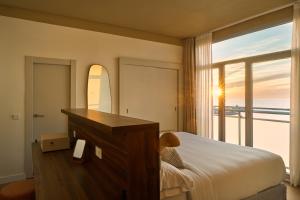 a bedroom with a bed and a large window at Hotel Riviera Costa del Sol - Adults Recommended in Benalmádena