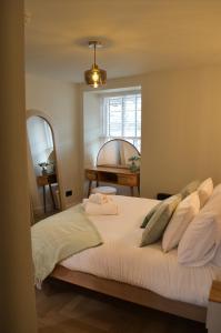 a bedroom with a bed with towels on it at Royal Six Apartments in Harrogate