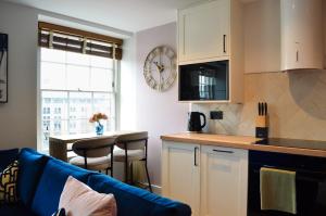 a kitchen with a couch and a table in a room at Royal Six Apartments in Harrogate +18 photos