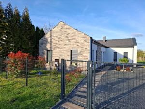 a house with a fence in front of it at Offline Home in Balatonőszöd