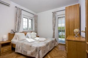 a bedroom with a bed and a window at Apartments Covic in Antonci