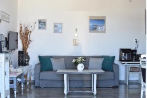 a living room with a couch and a table at Despina in Kritinía