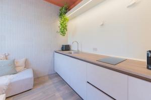 a kitchen with a sink and a counter top at Amagi Home in Montecchia di Crosara