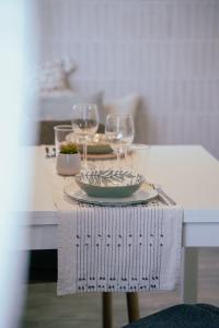 a table with wine glasses and a plate of food at Amagi Home in Montecchia di Crosara +30 photos