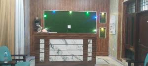 a living room with a large flat screen tv at Hotel Paradise in Chandīgarh