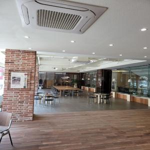 a room with tables and chairs and a brick wall at Ariana Hotel in Daegu