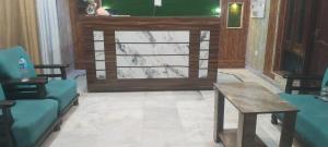 a lobby with a door with a table and chairs at Hotel Paradise in Chandīgarh +2 photos