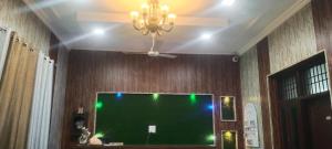 a large green screen in a room with a ceiling at Hotel Paradise in Chandīgarh