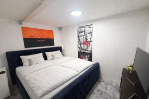 a bedroom with a bed and a painting on the wall at Schones Apartment mit Charme und privatem Garten in Schwieberdingen
