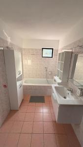 a bathroom with a tub and a sink and a bath tub at Pálava Chalupa in Pavlov +56 photos