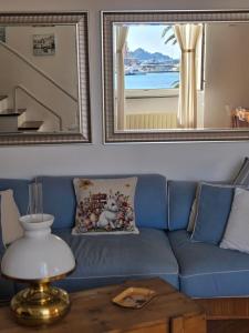 a blue couch in a living room with a window at Acquamarina in Rapallo