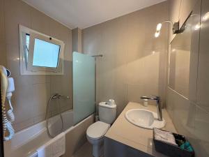 a bathroom with a toilet and a sink and a shower at Maisonettes Athina in Chrysi Ammoudia +24 photos