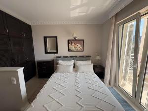 a large white bed in a room with a window at Maisonettes Athina in Chrysi Ammoudia