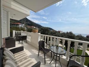 a patio with a table and chairs on a balcony at Maisonettes Athina in Chrysi Ammoudia