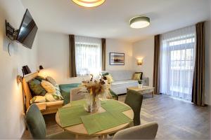 a living room with a table and a couch at Apartmány Lipno-Hory in Horní Planá +75 photos