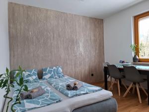 a bed with two teddy bears on it in a room at FEWO Erika in Presseggen