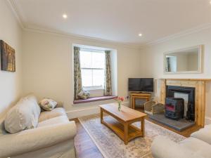 a living room with a couch and a fireplace at 6 Bed in Strathcarron oc-ca343 in Applecross