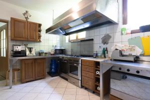 a kitchen with wooden cabinets and a stove top oven at Pensjonat Pod Długą Polaną in Nowy Targ