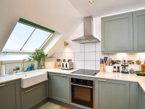 a kitchen with a sink and a stove top oven at 1 Bed in Burntisland oc-47388 in Kinghorn