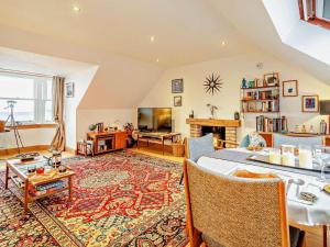 a living room with a table and a tv at 1 Bed in Burntisland oc-47388 in Kinghorn
