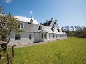 a large white building with a grass field in front of it at 2 Bed in Applecross oc-ca422 in Applecross +14 photos