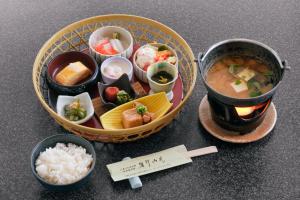 a tray of food with a bowl of soup and rice at 碧翠御苑 ゲストハウス風月庵 in Kyotango