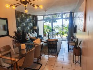 a living room with a table and a dining room at OceanFront- Whale Watch- On Beach- Stunning in Umdloti