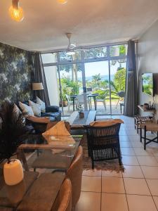 a living room with a couch and a table at OceanFront- Whale Watch- On Beach- Stunning in Umdloti