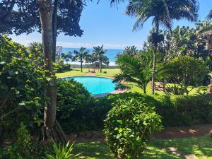 a swimming pool with the ocean in the background at OceanFront- Whale Watch- On Beach- Stunning in Umdloti