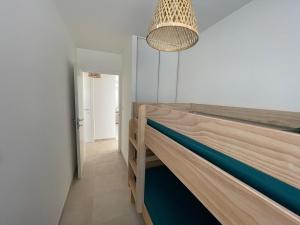 a room with two bunk beds and a chandelier at Magnifique T3 full équipé, 100m de la plage et piscine N60 in Linguizzetta +28 photos