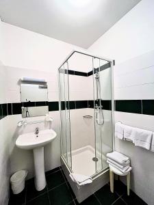 a bathroom with a shower and a sink at Le National Sète Centre Gare,Ascenseur in Sète +62 photos