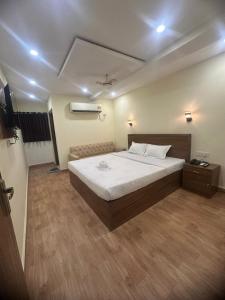 a bedroom with a large white bed in a room at Hotel Tu Casa in Kolkata +27 photos