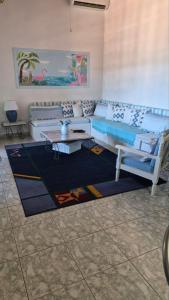 a living room with a couch and a table at Βίλα Πασιθέα in Khánia