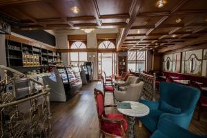 a bar with chairs and tables in a room at Hotel Ovo malo duše in Sarajevo