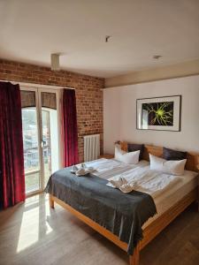 a bedroom with a large bed and a brick wall at Speicher Barth - Superior-Hotel in Barth +89 photos