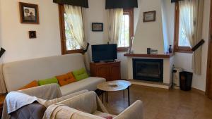 a living room with a couch and a fireplace at MEDDAYS Villa CARMEN in Miami Platja