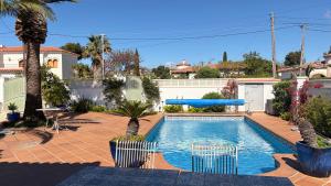 a swimming pool with a slide in a backyard at MEDDAYS Villa CARMEN in Miami Platja