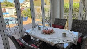 a table with chairs and a table with a box on it at MEDDAYS Villa CARMEN in Miami Platja