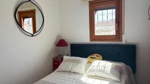 a bedroom with a bed with a blue headboard and a mirror at MEDDAYS Villa CARMEN in Miami Platja +40 photos