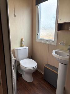 a small bathroom with a toilet and a sink at Bobby's Bolthole in Heysham +19 photos