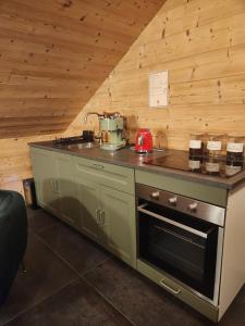 a kitchen with a stove top oven in a room at Love Room Fire Sens in Breurey-lès-Faverney