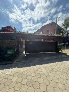 a house with a fence and a building at Refúgio da Vila in Ilhabela